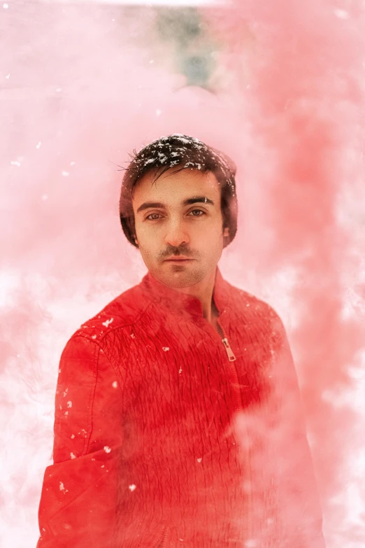 a man that is standing in the snow, an album cover, inspired by Matteo Pérez, pexels contest winner, light stubble with red shirt, color explosion, charli bowater, smoke grenade