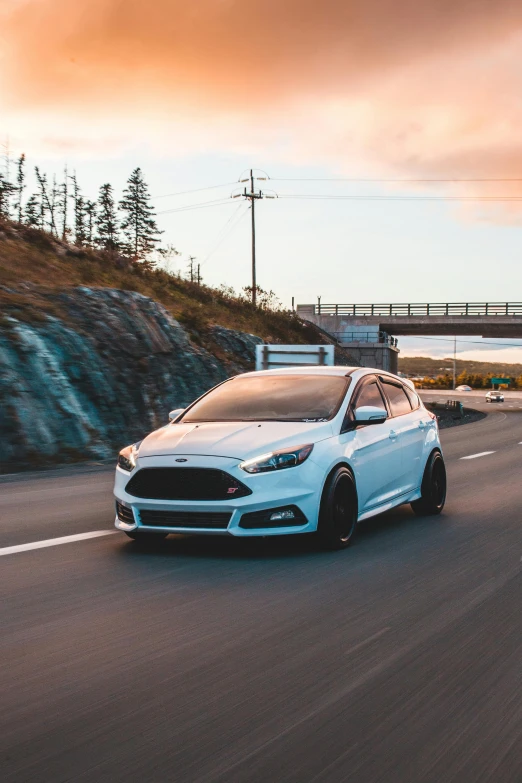 a white car driving down a road with a bridge in the background, epic stance, ford, focus stacked, aftermarket parts