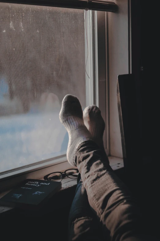 a person with their feet up on a window sill, trending on pexels, sitting at a control center, winter season, instagram post, very comfy]