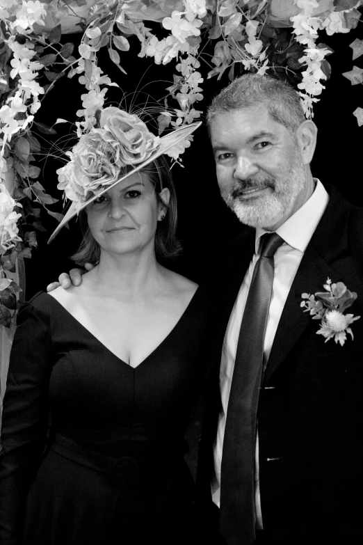 a black and white photo of a man and a woman, a black and white photo, fancy hat, stephen conroy, 5 5 yo, wedding