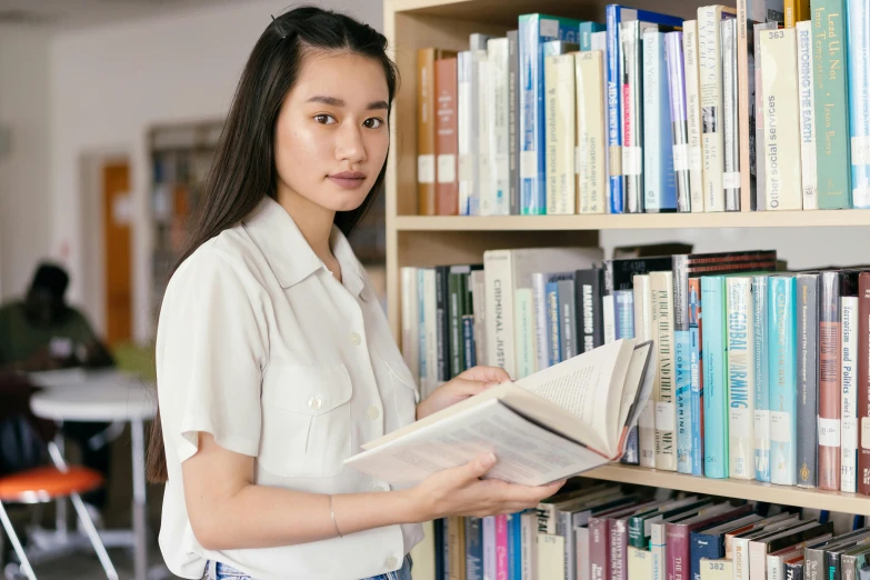 a woman reading a book in a library, unsplash, academic art, wearing school uniform, avatar image, asian human, a person standing in front of a