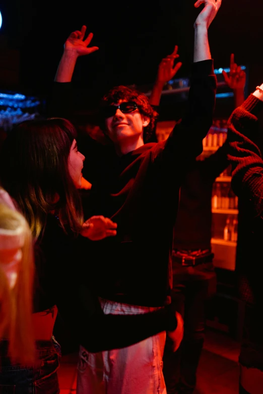 a group of people that are standing in the dark, severus snape dances in a bar, andy milonakis, dark shades, cinestill 800t eastmancolor