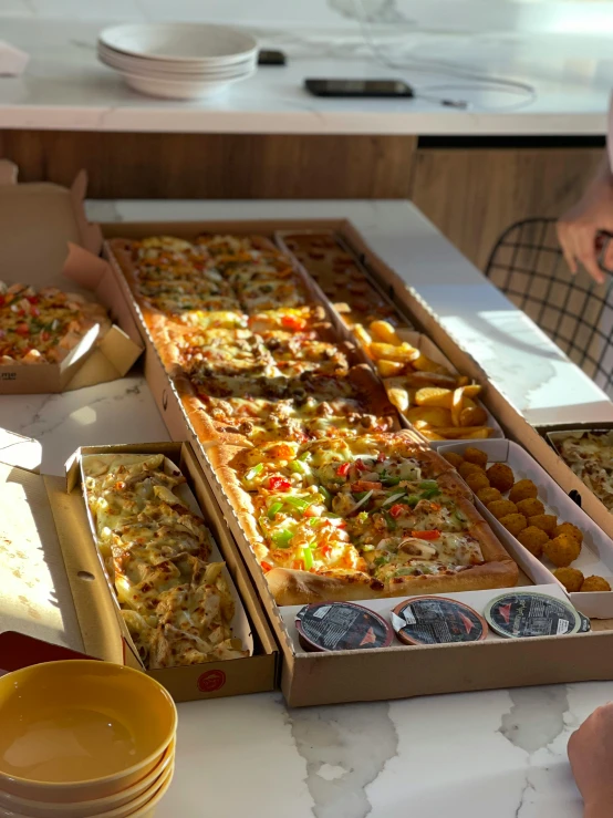 a group of people sitting at a table eating pizza, on a wooden tray, 6 pack, various sizes, all marble