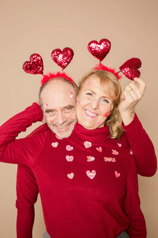 a man and woman posing for a picture with hearts on their heads, a photo, happening, wearing festive clothing, 5 5 yo, illustration », marthe jonkers