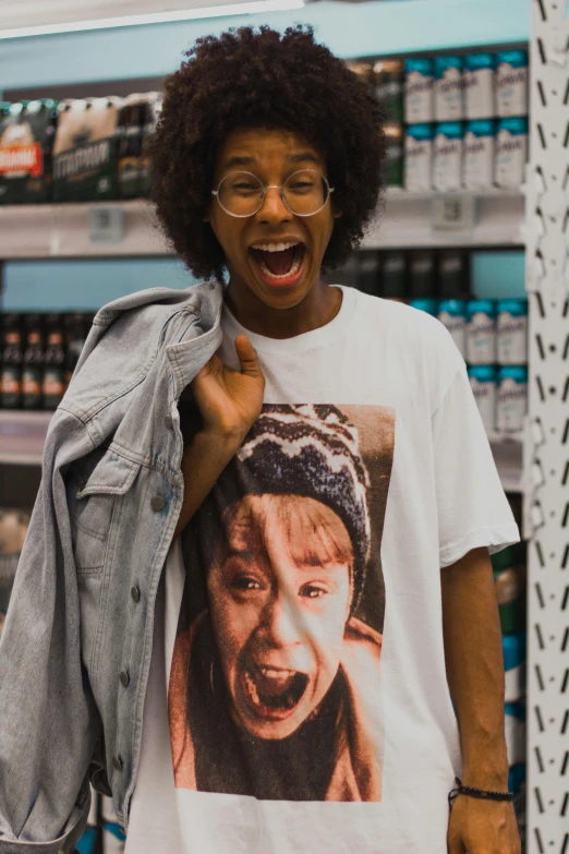 a woman wearing a t - shirt with a picture of a man on it, by Washington Allston, pexels contest winner, stood in a supermarket, sza, big teeth, nerds