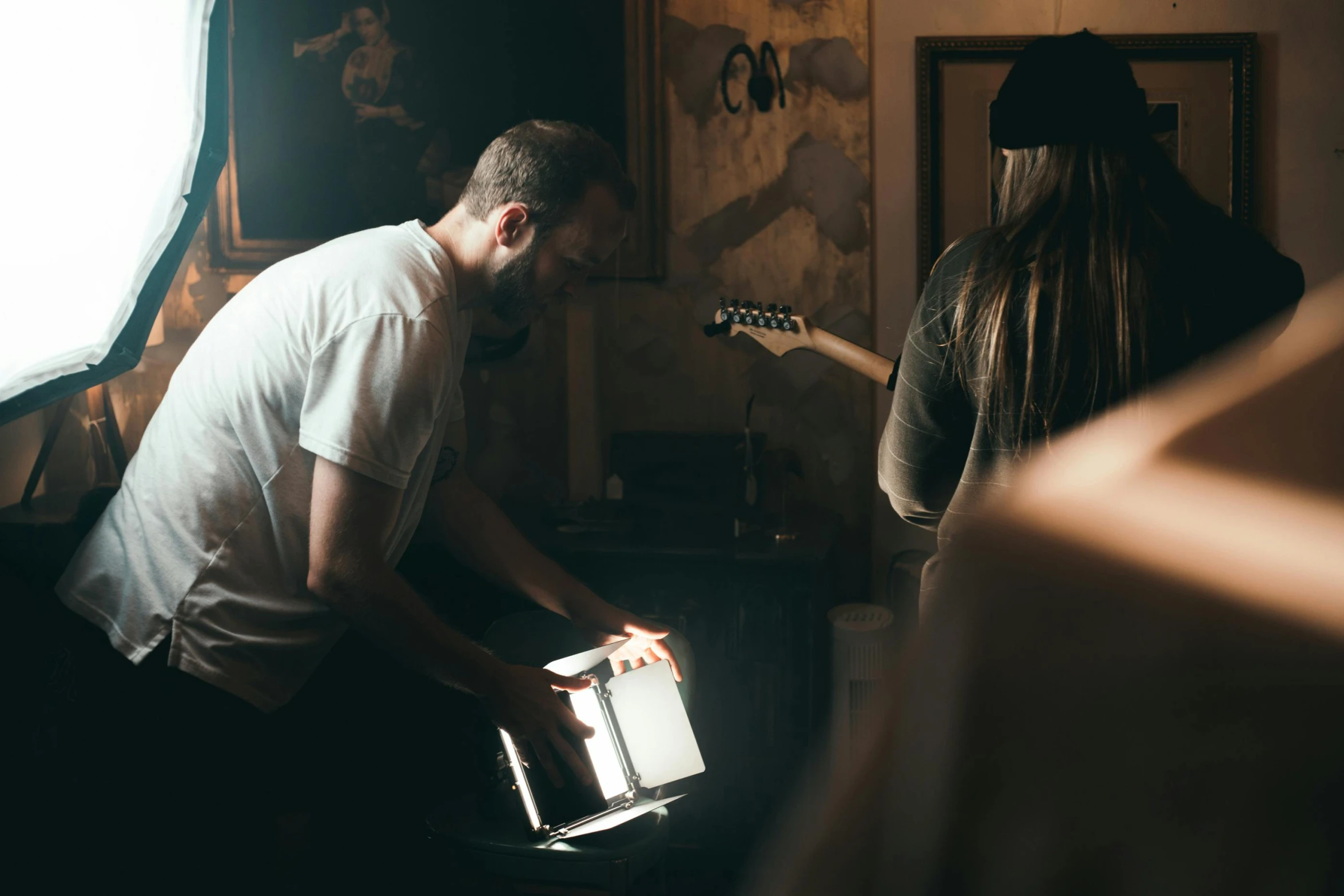 a man and a woman in a dark room, pexels contest winner, music being played, aussie baristas, full daylight, looking at the treasure box