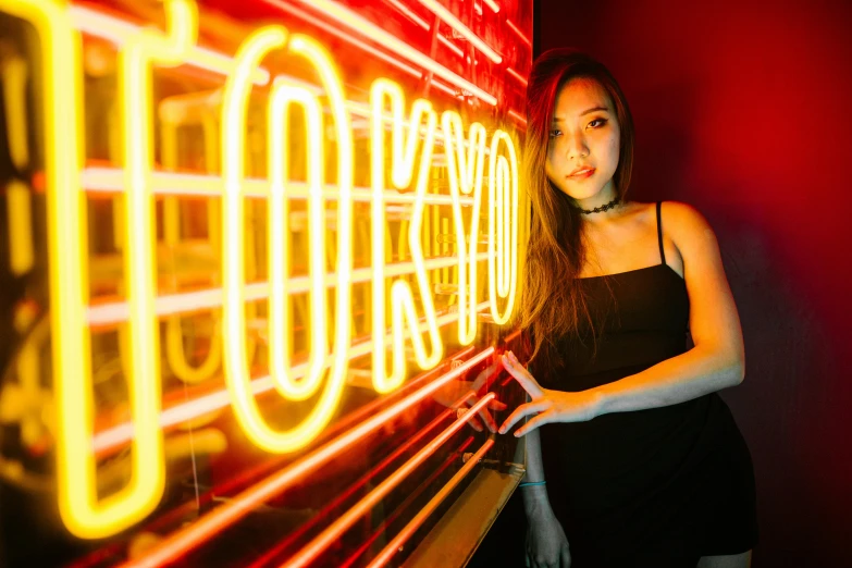 a woman standing in front of a neon sign, pexels contest winner, ukiyo, 1 8 yo, red and yellow light, half asian