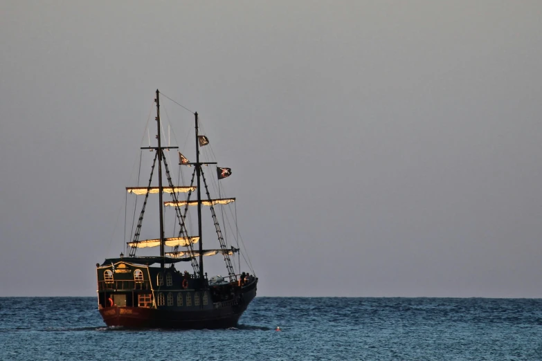 a large boat floating on top of a body of water, pexels contest winner, renaissance, pirate themed, cyprus, early evening, family friendly