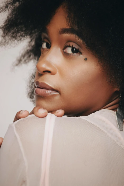 a close up of a person with an afro, an album cover, by Lily Delissa Joseph, trending on pexels, translucent skin, arm around her neck, looking from behind, confident pose