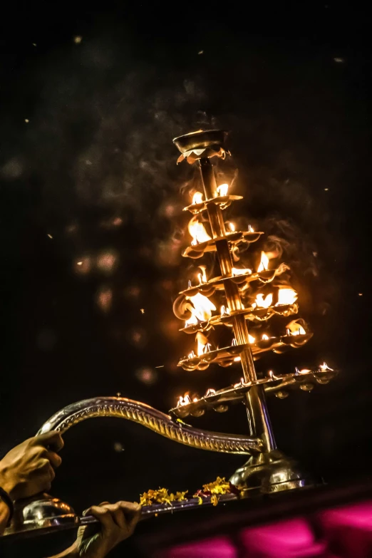 a lighted christmas tree sitting on top of a table, by Daniel Lieske, trending on unsplash, kinetic art, victorian fire ship, holding a giant flail, show from below, fire flaming serpent