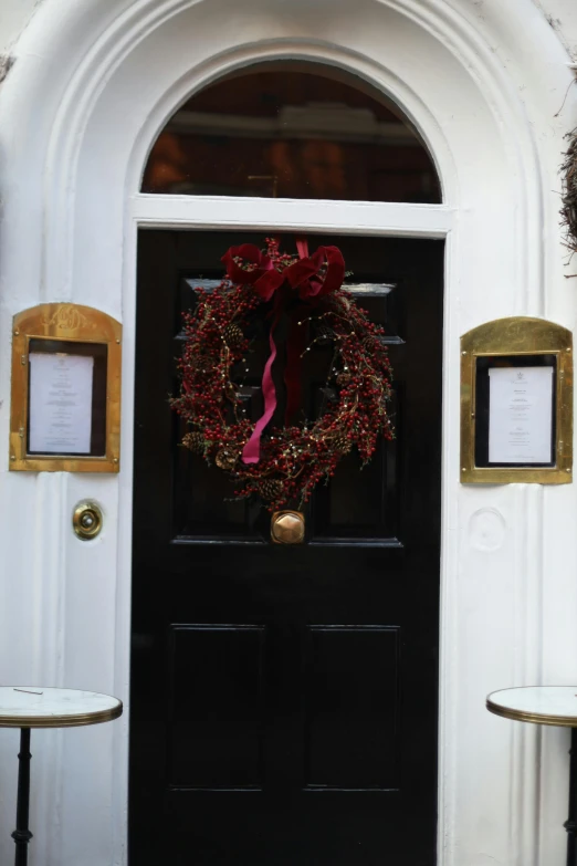 a black door with a wreath on it, inspired by Christopher Wren, private press, michelin star restaurant, twas brillig, award - winning crisp details ”, foil