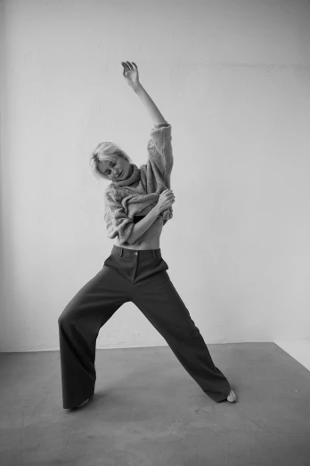 a black and white photo of a woman doing yoga, by Clifford Ross, elle fanning, gestures, baggy pants, courtesy of moma