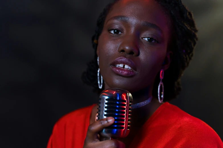 a woman holding a microphone in front of her face, an album cover, pexels, ( ( dark skin ) ), portrait n - 9, thumbnail, musician