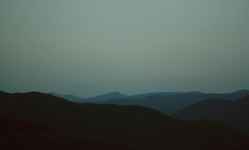 a person flying a kite on top of a mountain, an album cover, inspired by Elsa Bleda, tonalism, silhouette :7, new hampshire mountain, muted color (blues, hills