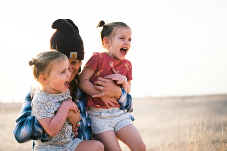 a man holding two little girls in a field, pexels contest winner, incoherents, both laughing, australian, denim, avatar image