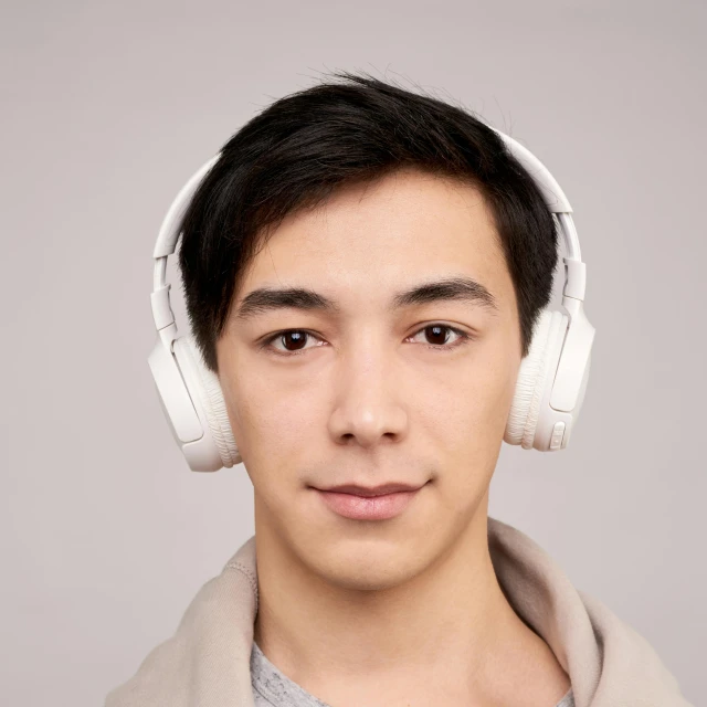 a close up of a person wearing headphones, reddit, hurufiyya, an all white human, shot with sony alpha, on a pale background, asian male