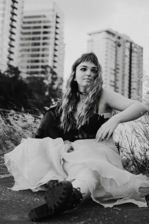 a couple of women sitting next to each other, a black and white photo, happening, side portrait of imogen poots, outside on the ground, singer songwriter, profile image