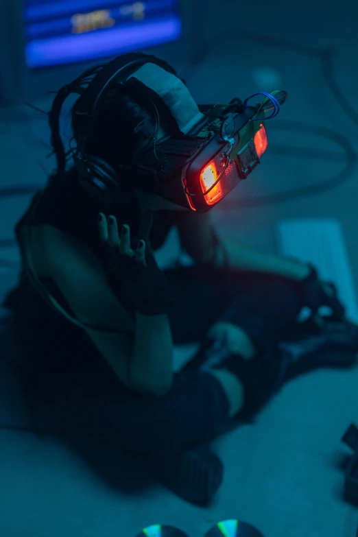 a person sitting on the floor with a pair of headphones on, cyberpunk art, wearing vr goggles, red glowing eyes, like a cyberpunk workshop, volumetric underwater lighting