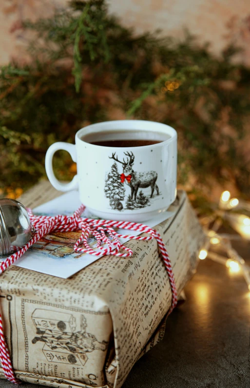 a book sitting on top of a table next to a cup of coffee, folk art, holiday season, vintage inspired, hero shot, tag