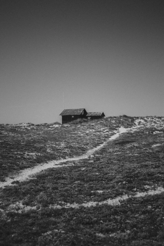 a black and white photo of a house on a hill, a black and white photo, flickr, interior of a mountain hut, walking to the right, ( ( photograph ) ), hasselblad photograph