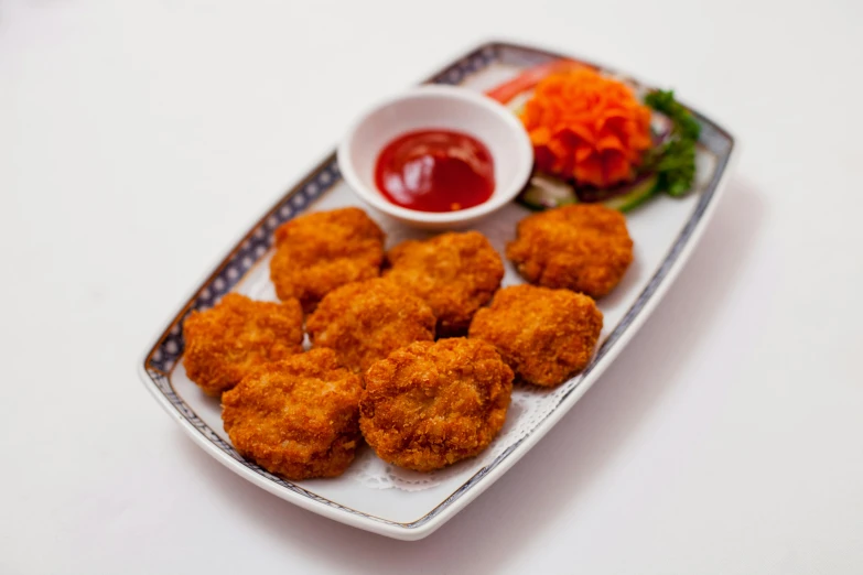 a white plate topped with chicken nuggies next to a small bowl of ketchup, by Kishi Ganku, detailed product image, monsoon, square, 千 葉 雄 大