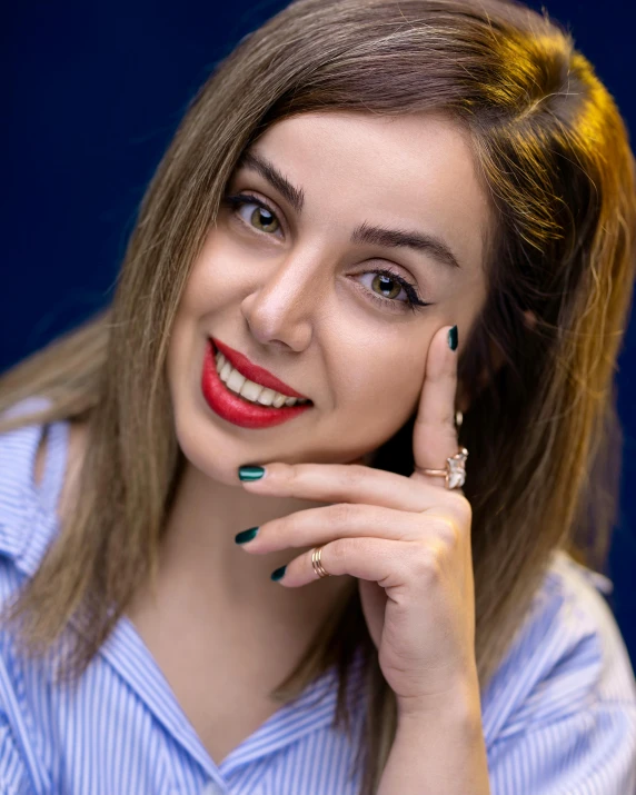 a woman in a blue shirt posing for a picture, by Julia Pishtar, trending on pexels, antipodeans, cheeky smile with red lips, young beautiful amouranth, painted nails, romanian