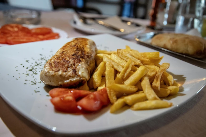 a close up of a plate of food on a table, french fries on the side, greek romanian, chicken, são paulo