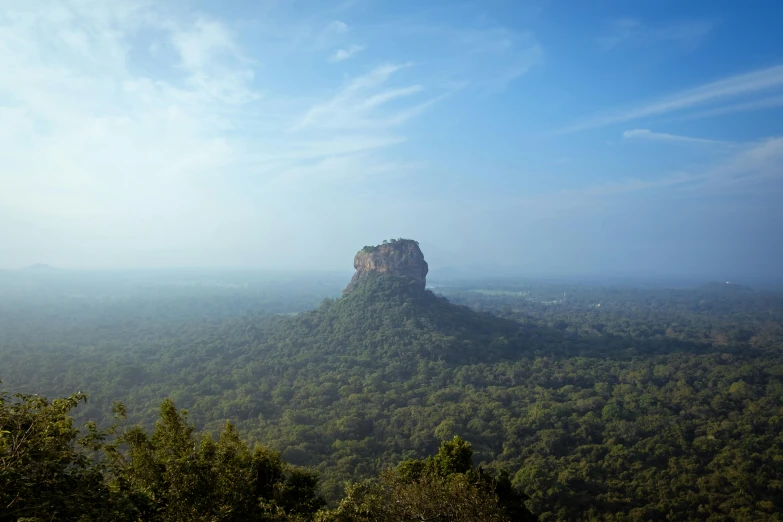 a large rock sitting on top of a lush green hillside, hurufiyya, palace floating in the sky, conde nast traveler photo