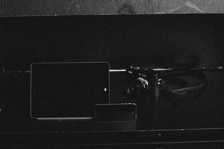 a black and white photo of an old typewriter, a black and white photo, by Mathias Kollros, vanitas, smartphone footage, dark ambient album cover, on a wooden tray, television still