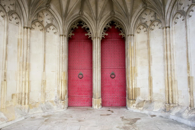 a couple of red doors sitting inside of a building, by Alison Debenham, pexels contest winner, international gothic, alabaster gothic cathedral, warwick saint, pink, 1 4 9 3