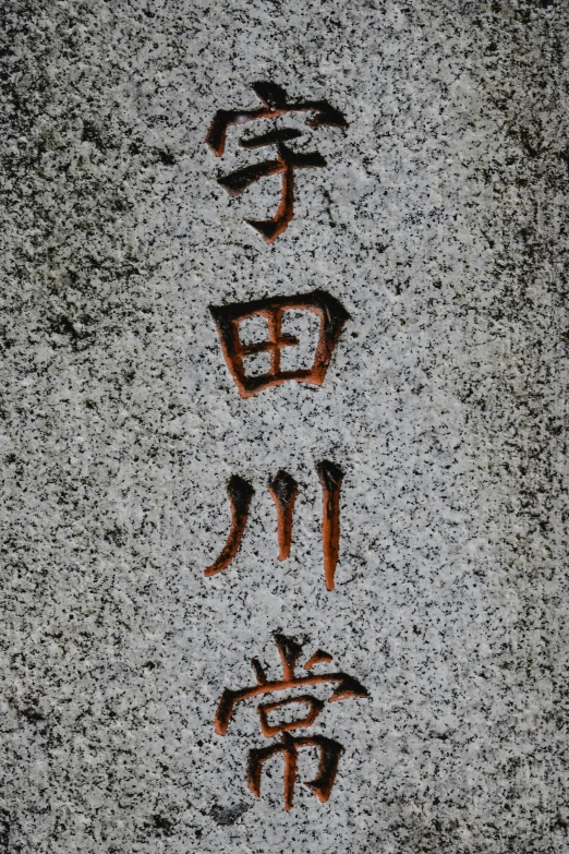 a close up of a stone with writing on it, an album cover, inspired by Sesshū Tōyō, unsplash, sōsaku hanga, grey orange, tall, panel, grave