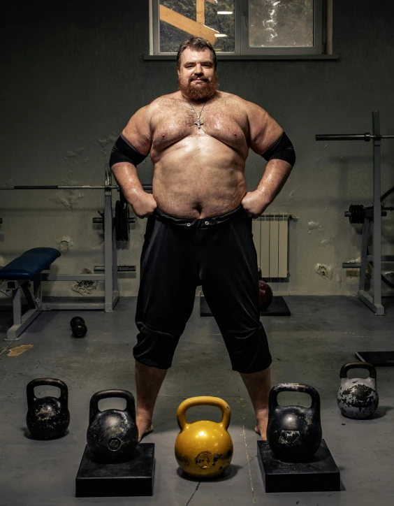 a man standing next to a kettlebell in a gym, featured on reddit, transgressive art, three hairy fat cave people, portrait photo, lgbtq, made of flesh and muscles