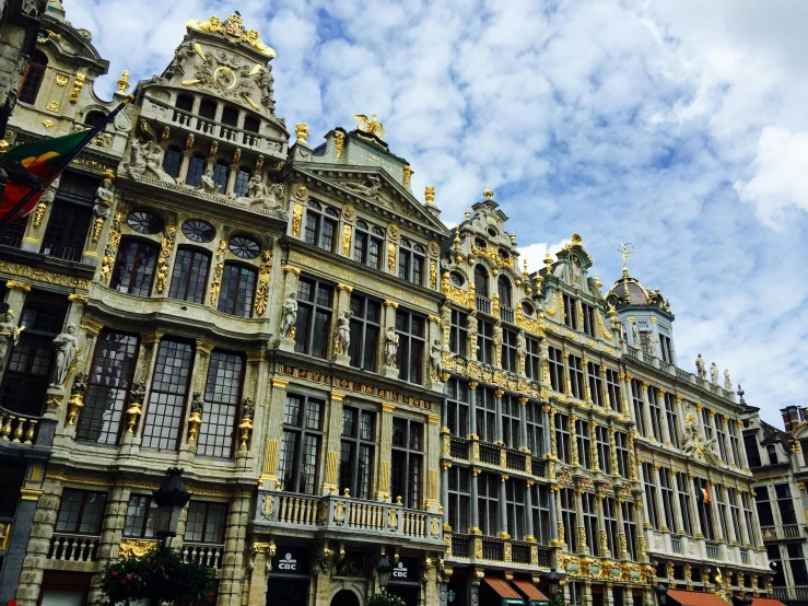 a very tall building with a lot of windows, pexels contest winner, baroque, brussels, vibrant but dreary gold, profile image, square