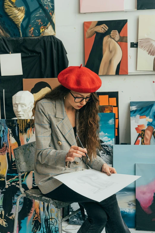 a woman in a red beret writing on a piece of paper, a fine art painting, trending on pexels, tall female emo art student, creativity in fashion design, asher duran, indi creates