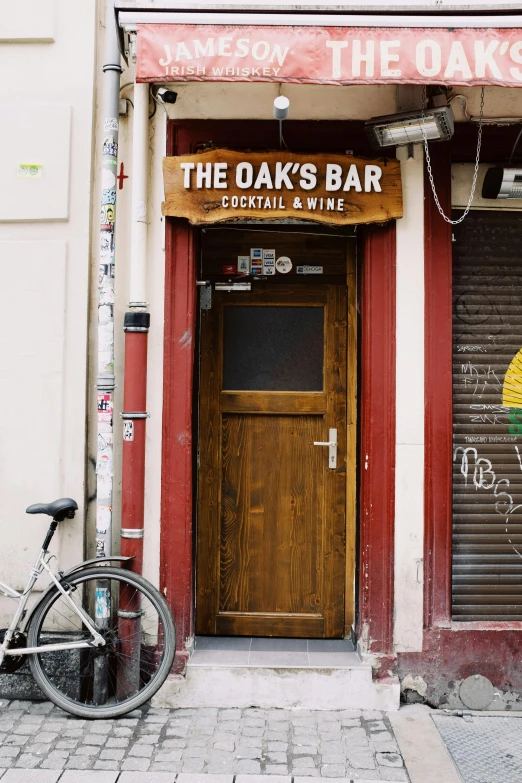 a bicycle is parked in front of the oak's bar, inspired by Isaac van Ostade, trending on unsplash, graffiti, doorway, cocktail bar, y2k”, thumbnail