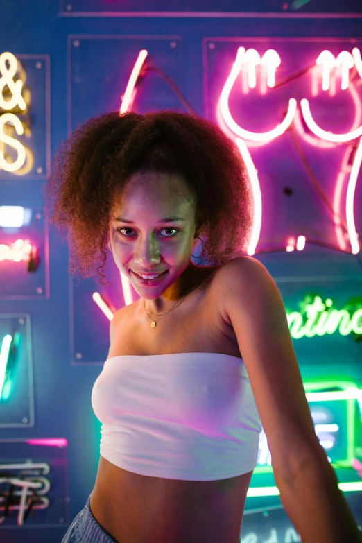 a woman standing in front of a neon sign, inspired by David LaChapelle, pexels contest winner, nathalie emmanuel, attractive girl, at a bar, portrait sophie mudd