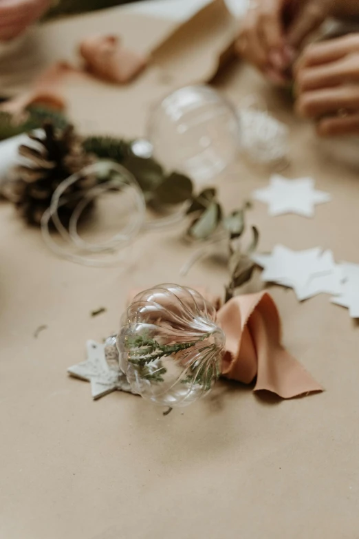 a group of people making christmas decorations on a table, by Anna Boch, pexels contest winner, baroque, soft details, mixed materials, transparent background, close-up product photo