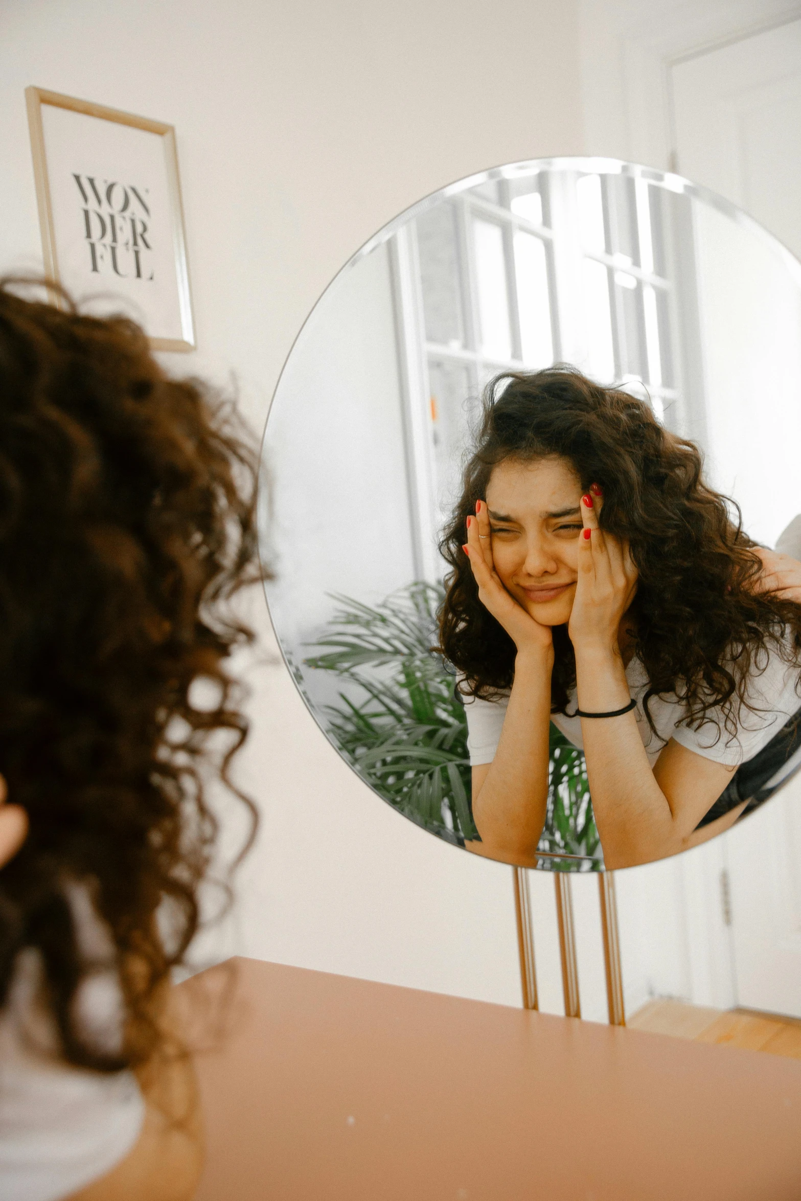 a woman brushing her hair in front of a mirror, a picture, trending on pexels, brown curly hair, woman crying, panoramic view of girl, half - length photo