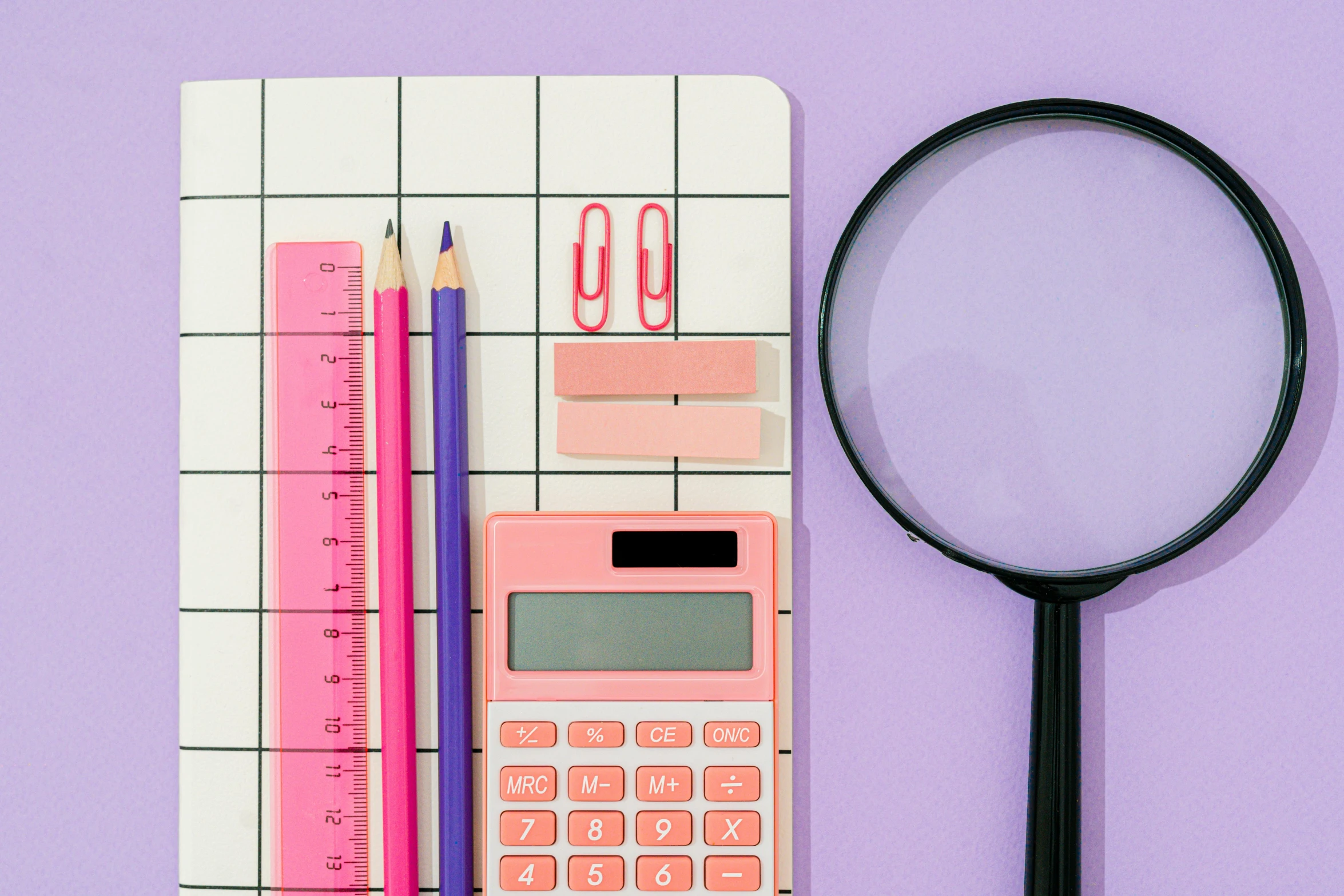 a pink calculator sitting on top of a piece of paper next to a magnifying glass, by Julia Pishtar, trending on pexels, purple checkerboard, square lines, school curriculum expert, pastel style