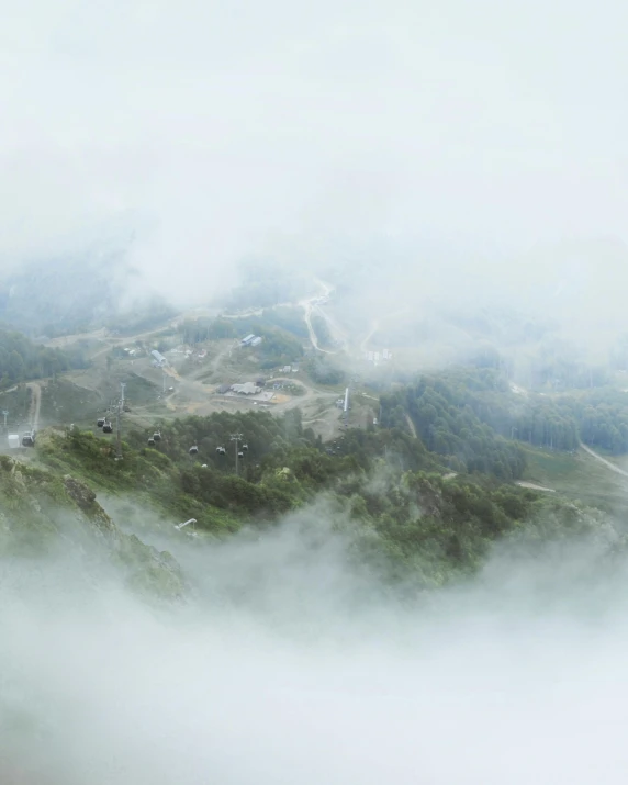 a group of people standing on top of a mountain, a matte painting, pexels contest winner, sumatraism, white fog, viewed from bird's-eye, tilt-shifted, panorama