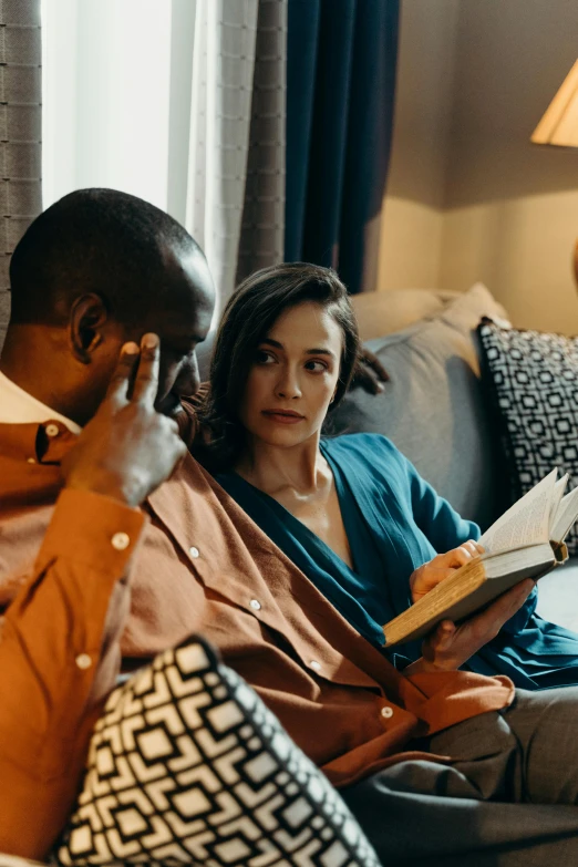 a man and woman sitting on a couch reading a book, a portrait, pexels contest winner, happening, wearing a grey robe, bowater charlie and brom gerald, diverse, concern