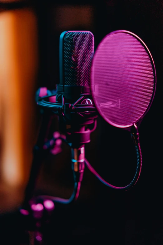 a close up of a microphone in a recording studio, an album cover, trending on pexels, holography, magenta and blue, standing microphones, avatar image, shot on sony a 7