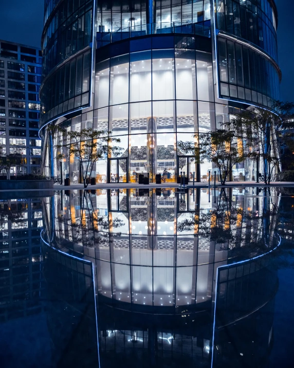 a reflection of a building in a pool at night, in magnificent shopping mall, set on singaporean aesthetic, high-quality photo, thumbnail