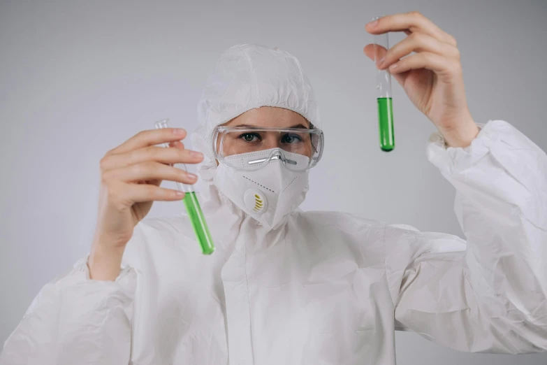 a man in a lab coat holding two test tubes, an album cover, trending on pexels, green slime, girl wearing uniform, technical suit, avatar image