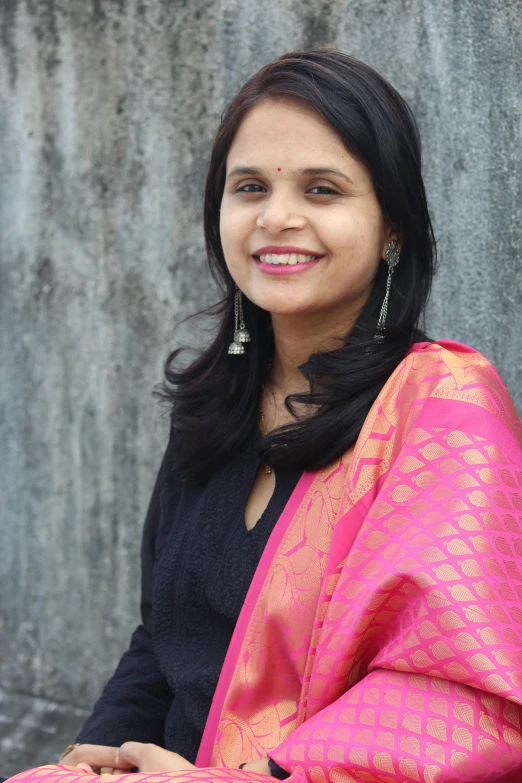 a woman sitting in front of a wall, a picture, samikshavad, professional profile photo, wearing dark silk, profile image, standing