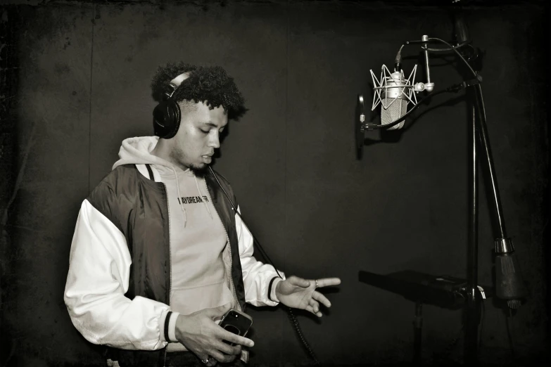 a man wearing headphones standing in front of a microphone, an album cover, instagram, hurufiyya, in a studio, syd, b - roll, with afro