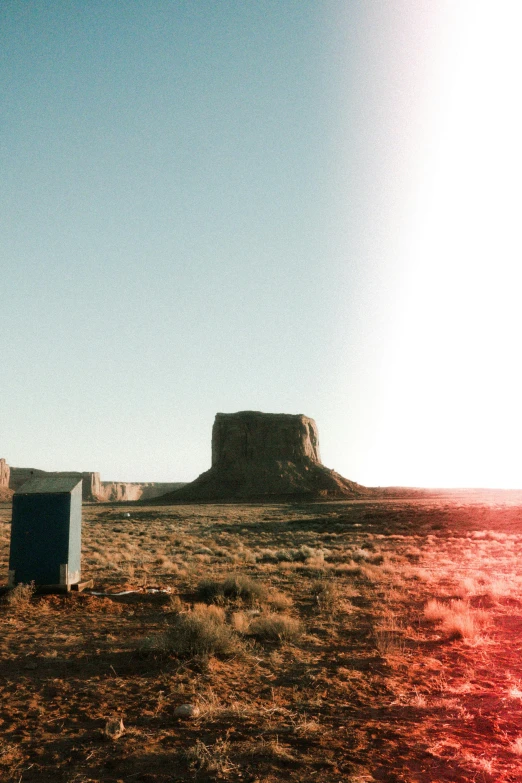 a refrigerator sitting in the middle of a desert, unsplash contest winner, land art, style of monument valley, expired color film, portapotty, panoramic shot