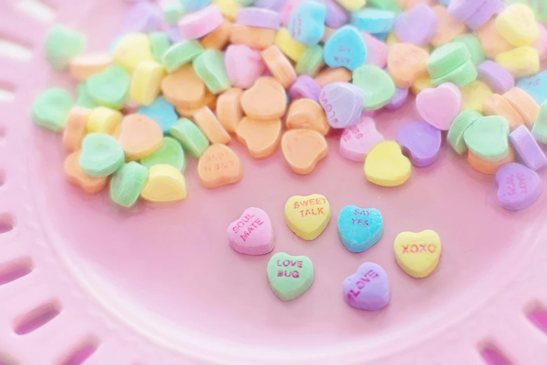 a paper plate with conversation hearts on it, a photo, pexels, 🎀 🗡 🍓 🧚, a table full of candy, background image, 3 4 5 3 1