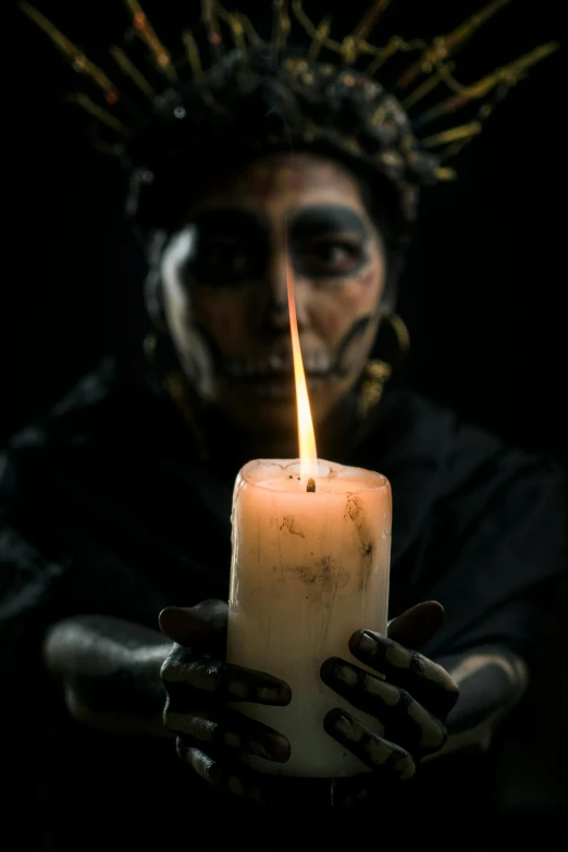 a person holding a candle in their hands, an album cover, inspired by Nicola Samori, pexels contest winner, vanitas, mayan priestess, profile image, peru, menacing look