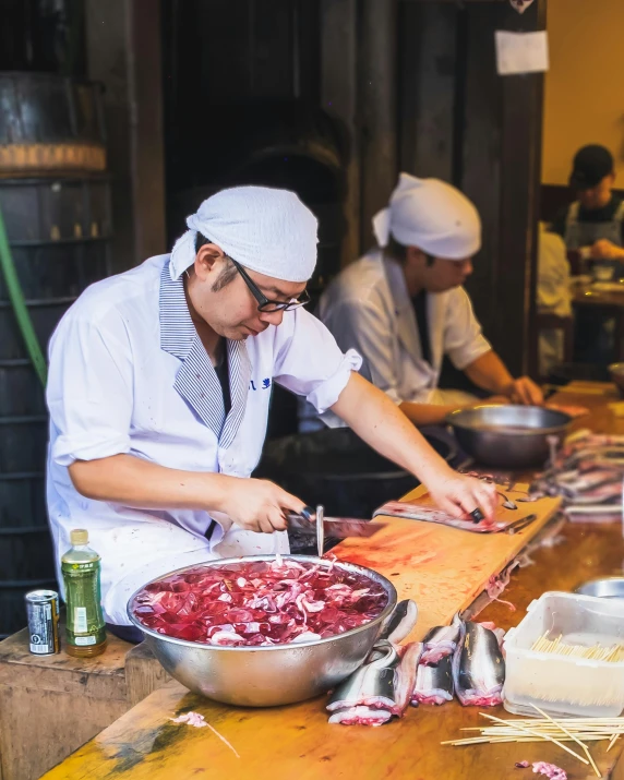 a group of chefs preparing food in a kitchen, tokyo izakaya scene, profile image, fish seafood markets, multiple stories